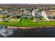 Aerial shot highlighting the backyard with green lawn and a serene lake view at 18855 Hampstead Heath Ct, Land O Lakes, FL 34638