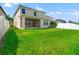 Large backyard featuring green lawn, a covered patio and view of the house at 18855 Hampstead Heath Ct, Land O Lakes, FL 34638