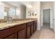 Bathroom featuring double sink vanity, granite countertop, and tiled floors at 18855 Hampstead Heath Ct, Land O Lakes, FL 34638