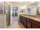 Bathroom showcasing a glass shower, double sink vanity, and granite countertop at 18855 Hampstead Heath Ct, Land O Lakes, FL 34638