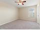 Bedroom featuring neutral carpet, a ceiling fan, and a window with blinds at 18855 Hampstead Heath Ct, Land O Lakes, FL 34638