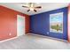 Colorful bedroom featuring neutral carpet and a window with a view at 18855 Hampstead Heath Ct, Land O Lakes, FL 34638