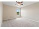 Bedroom featuring neutral carpet, a ceiling fan, and a window with a view at 18855 Hampstead Heath Ct, Land O Lakes, FL 34638