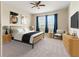 Digitally staged bedroom with neutral colors, carpet flooring, and ceiling fan at 18855 Hampstead Heath Ct, Land O Lakes, FL 34638