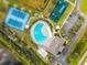 Aerial view of the community pool area, tennis courts, and playground amenities at 18855 Hampstead Heath Ct, Land O Lakes, FL 34638