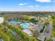 An aerial view showcases the community pool, tennis courts, and playground amenities at 18855 Hampstead Heath Ct, Land O Lakes, FL 34638