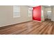 Large dining area with bright red wall accent, wood floors, and lots of natural light at 18855 Hampstead Heath Ct, Land O Lakes, FL 34638