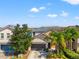 Inviting home boasts a well-maintained lawn, a spacious garage, and mature palm trees at 18855 Hampstead Heath Ct, Land O Lakes, FL 34638
