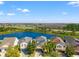 Beautiful homes with a tranquil water view and blue skies create an inviting neighborhood at 18855 Hampstead Heath Ct, Land O Lakes, FL 34638