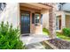 Welcoming front entrance with a stone pillar and a well-maintained yard adds curb appeal at 18855 Hampstead Heath Ct, Land O Lakes, FL 34638