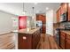 Kitchen island with granite counters, stainless steel appliances, and pendant lighting at 18855 Hampstead Heath Ct, Land O Lakes, FL 34638
