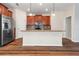 Kitchen island featuring granite countertops, wood cabinetry, and stainless steel appliances at 18855 Hampstead Heath Ct, Land O Lakes, FL 34638