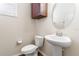 Cozy powder room featuring a pedestal sink and cabinet offering a functional space at 18855 Hampstead Heath Ct, Land O Lakes, FL 34638