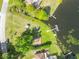 Aerial view of the community waterfront access point with dock and playground, surrounded by lush landscaping at 22017 Bass Pl, Land O Lakes, FL 34639