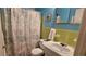 A full bath features turquoise walls, vintage tiles, and a white sink and toilet at 2459 Franciscan Dr # 35, Clearwater, FL 33763