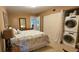 Bedroom with ensuite bathroom, dresser, nightstand, and washer/dryer at 2459 Franciscan Dr # 35, Clearwater, FL 33763