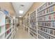 Brightly lit library with extensive collection of DVDs and books on well-stocked white shelving at 292 Salem Ave # 4, Palm Harbor, FL 34684