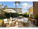 Inviting backyard showcasing a brick patio with stylish outdoor furniture, umbrellas, and tropical foliage, creating a serene retreat at 308 S Arrawana Ave, Tampa, FL 33609