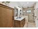 This bright bathroom includes a double sink vanity and a large, tiled walk-in shower at 308 S Arrawana Ave, Tampa, FL 33609