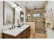 Bright bathroom featuring double sink vanity and spacious shower at 308 S Arrawana Ave, Tampa, FL 33609