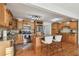 Beautiful kitchen features an island with seating, granite counters, stainless steel appliances, and wood cabinetry at 308 S Arrawana Ave, Tampa, FL 33609