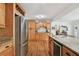 Spacious kitchen with granite countertops, stainless steel appliances, and wood cabinetry at 308 S Arrawana Ave, Tampa, FL 33609