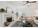 Cozy living room with a fireplace, mantle, and a large rug at 308 S Arrawana Ave, Tampa, FL 33609