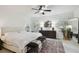 Bright primary bedroom features a ceiling fan, neutral colors, and a large area rug at 308 S Arrawana Ave, Tampa, FL 33609