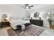 Bright primary bedroom features a ceiling fan, neutral colors, and a large area rug at 308 S Arrawana Ave, Tampa, FL 33609