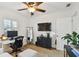 Bright home office featuring a ceiling fan, white desk, neutral rug, and comfortable seating area at 308 S Arrawana Ave, Tampa, FL 33609