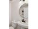 Bright powder room featuring a pedestal sink and bronze fixtures at 308 S Arrawana Ave, Tampa, FL 33609
