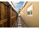 Narrow side yard with gravel and stepping stone path between homes at 308 S Arrawana Ave, Tampa, FL 33609