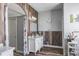 A well-maintained bathroom with a sleek vanity, wood look flooring, and neutral colors at 4037 Auston Way, Palm Harbor, FL 34685