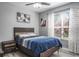 Bedroom with a wooden-framed bed, modern side table, ceiling fan, and large window at 4037 Auston Way, Palm Harbor, FL 34685
