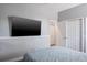 Neutral bedroom with a TV, wood-look floors, and white doors at 4037 Auston Way, Palm Harbor, FL 34685