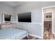 Bedroom featuring wood floors, gray walls, a dresser, a TV, and a closet at 4037 Auston Way, Palm Harbor, FL 34685