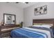 This bedroom features a lovely accent wall decoration, a leaf in a vase, and a wooden dresser at 4037 Auston Way, Palm Harbor, FL 34685
