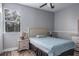 Comfortable bedroom features a wood floor, ceiling fan, and neutral paint at 4037 Auston Way, Palm Harbor, FL 34685