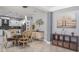 Dining area with ornate chairs, glass-top table, and open view to a modern kitchen space at 4037 Auston Way, Palm Harbor, FL 34685
