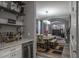 Dining room area adjacent to a dry bar, showcasing a modern table setting and seamless flow to the living space at 4037 Auston Way, Palm Harbor, FL 34685