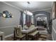 Dining room with a stylish table set, modern lighting, and an arched entryway into the adjacent living space at 4037 Auston Way, Palm Harbor, FL 34685