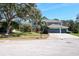 Beautiful home with lush landscaping, three-car garage, and a well-manicured lawn at 4037 Auston Way, Palm Harbor, FL 34685