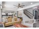 Bright living room with open floor plan connecting to the kitchen and staircase at 4037 Auston Way, Palm Harbor, FL 34685