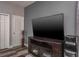 Living room with a large flat-screen TV on a console table, wood floors, and a water cooler at 4037 Auston Way, Palm Harbor, FL 34685
