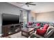 The spacious living room features a large sectional sofa, ceiling fan, and lots of natural light at 4037 Auston Way, Palm Harbor, FL 34685
