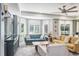Living room with large windows, plantation shutters, comfortable seating, and stylish decor at 4037 Auston Way, Palm Harbor, FL 34685