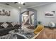 Cozy living room with gray walls, decor, and open staircase featuring modern, comfortable seating and a stylish rug at 4037 Auston Way, Palm Harbor, FL 34685