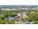An aerial shot showcases a home in a tree-lined neighborhood with a cityscape in the background at 5909 Canton S St, St Petersburg, FL 33712