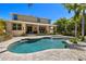 Backyard featuring a pool, covered patio, lush landscaping, and a two-story home at 5909 Canton S St, St Petersburg, FL 33712