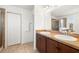 Bathroom with dual sinks, dark wood cabinetry, tile flooring, and glass-enclosed shower at 5909 Canton S St, St Petersburg, FL 33712